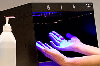 "Handcheck" som belyser händerna med ultraviolett ljus och avslöjar mängden bakterier.